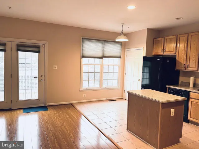 a view of empty room with window and wooden floor