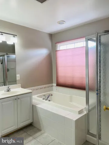a bathroom with a bathtub and a sink