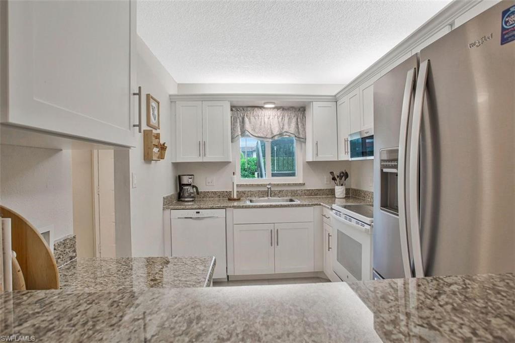 4258 27th Court Southwest, Unit 106 Naples, FL 34116 - Photo 8 of 19 Convenient pass thru to and from the dining area