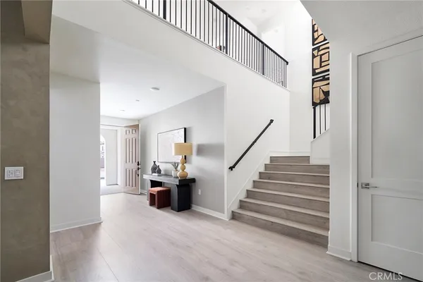 a view of entryway and hall with wooden floor