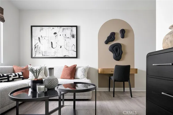 a living room with furniture and a painting on the wall