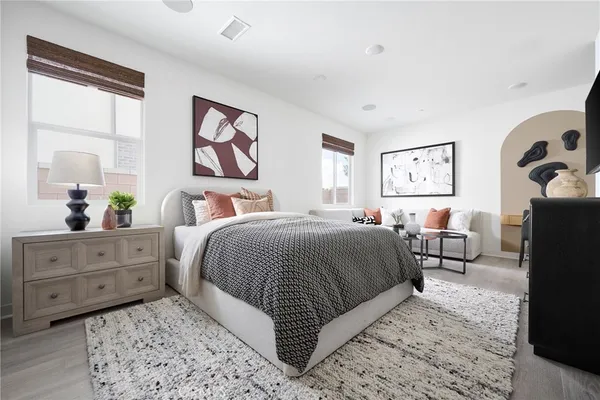 a bedroom with a large bed and a dresser