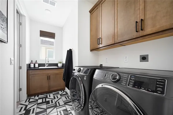 a view of a storage and utility room with washer and dryer