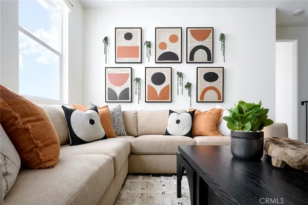 a living room with furniture and painting on the wall