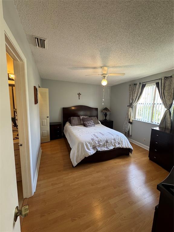 5681 Riverside Drive, Unit 203 Pompano Beach, FL 33067 - Photo 11 of 14 a bedroom with a bed window and a mirror