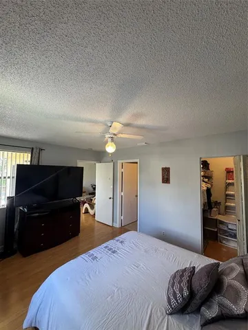 a bedroom with a bed and a television