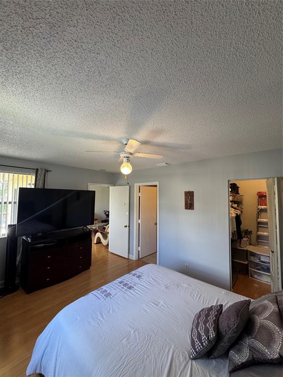 5681 Riverside Drive, Unit 203 Pompano Beach, FL 33067 - Photo 12 of 14 a bedroom with a bed and a television