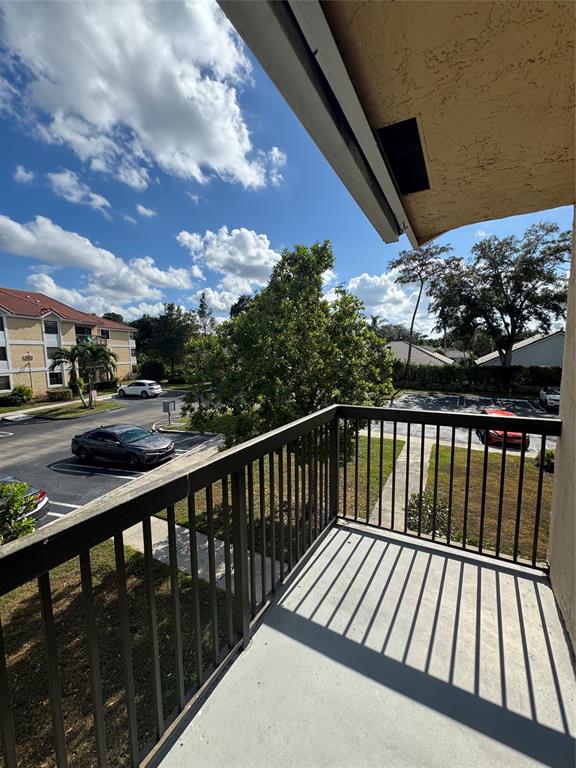 5681 Riverside Drive, Unit 203 Pompano Beach, FL 33067 - Photo 9 of 14 a view of balcony with wooden floor