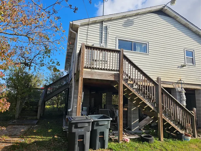 a view of a house with backyard and deck