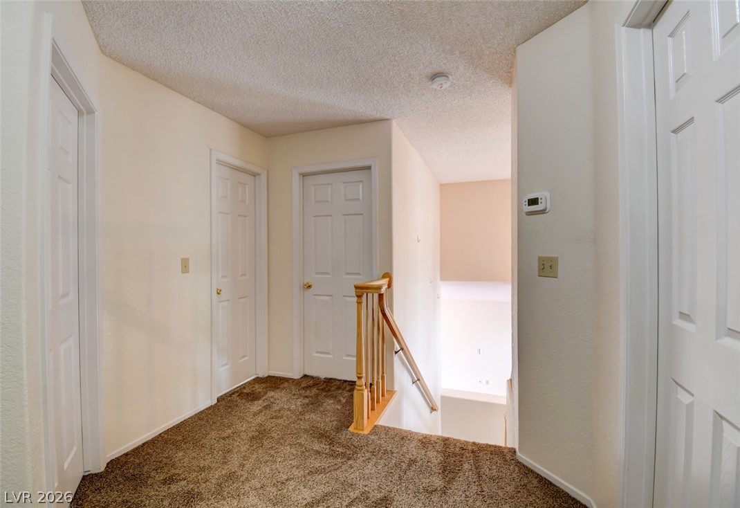 5 Tarryall Terrace Henderson, NV 89074 - Photo 31 of 44 A well-maintained landing with soft carpeting leads to various rooms and the descending staircase.