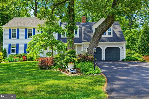 a front view of a house with a garden and plants