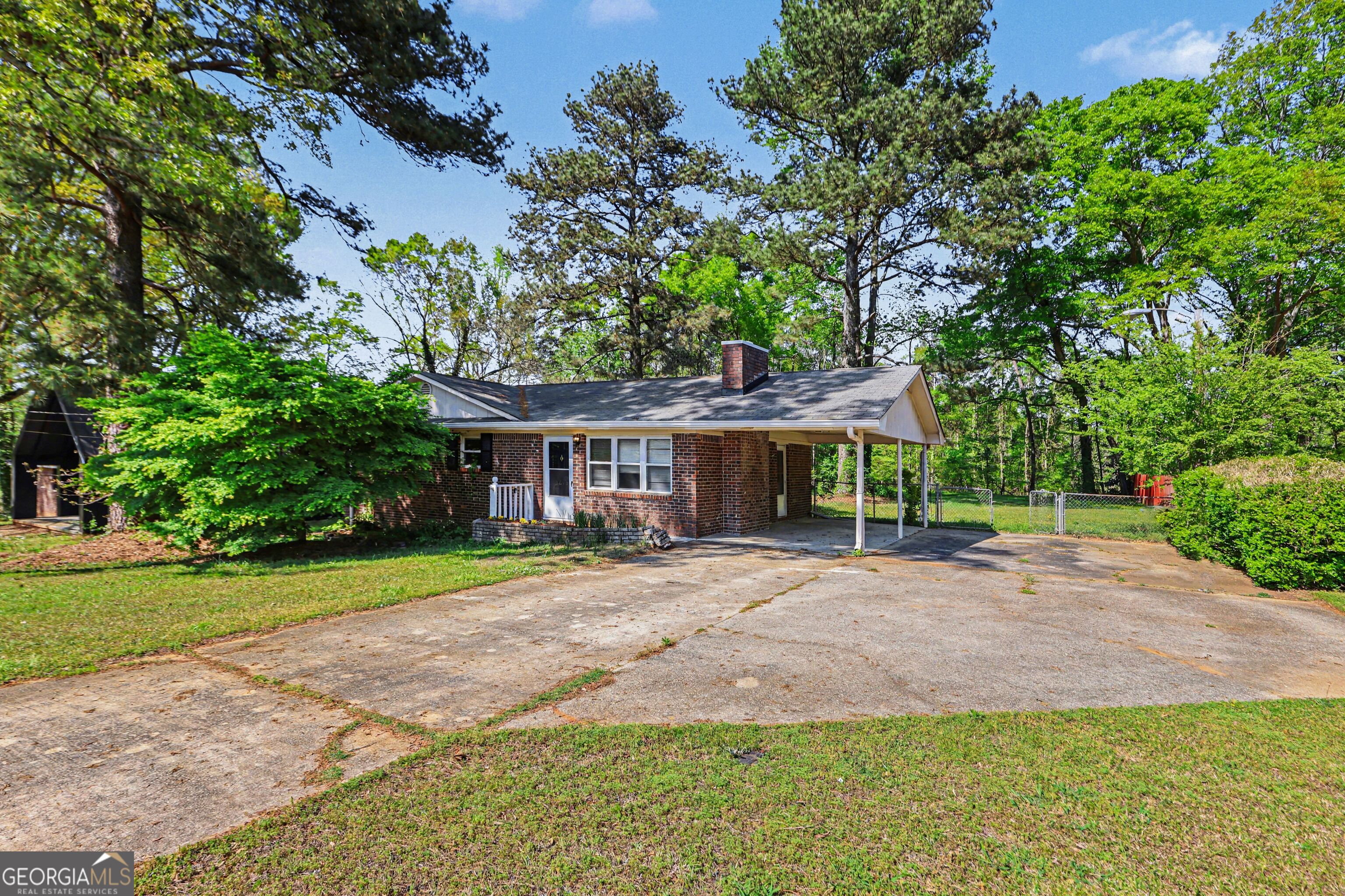3670 Goodwin Road Austell, GA 30106 - Photo 3 of 16 a front view of a house with a yard and trees