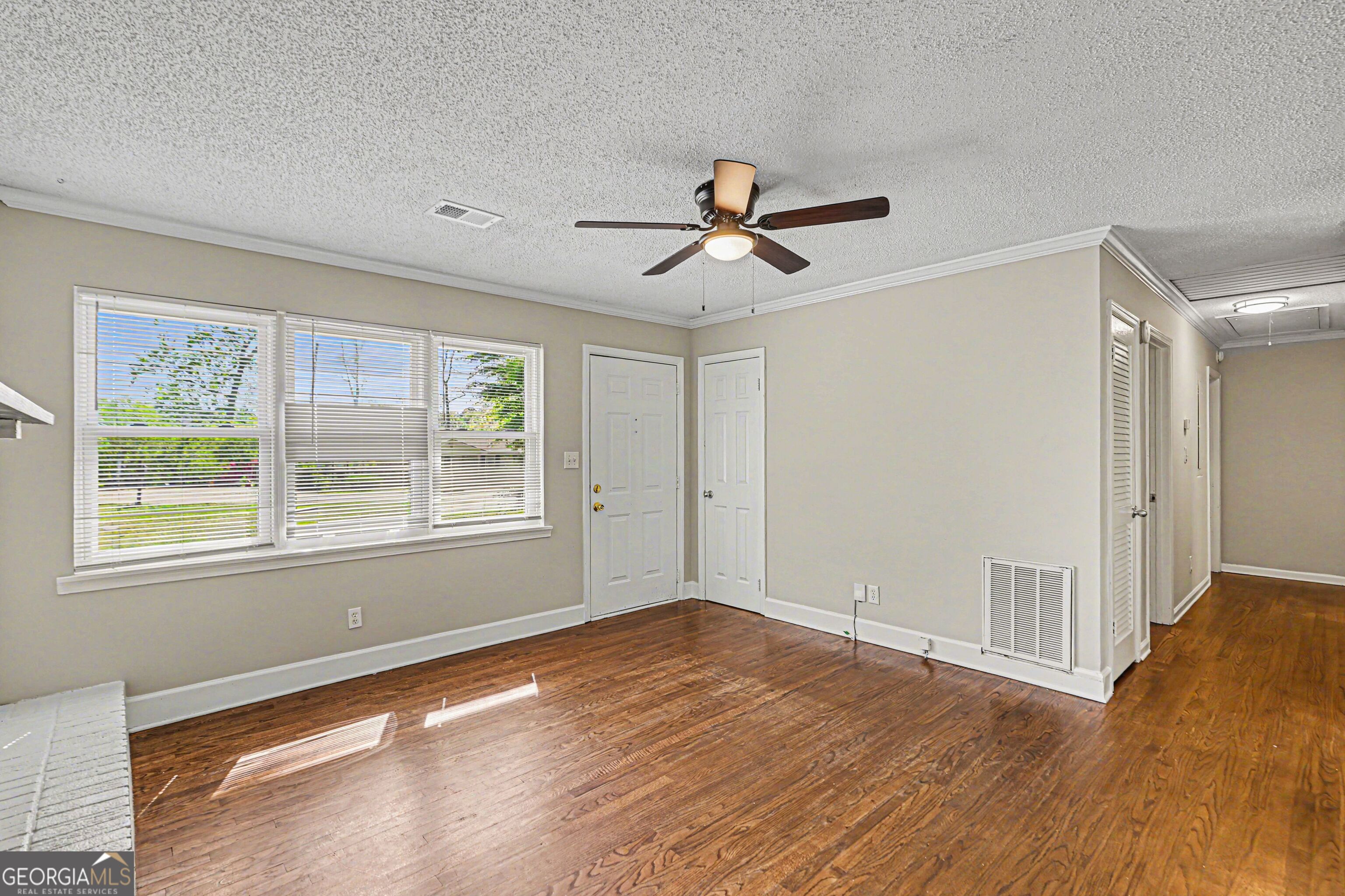 3670 Goodwin Road Austell, GA 30106 - Photo 6 of 16 a view of empty room with wooden floor and fan