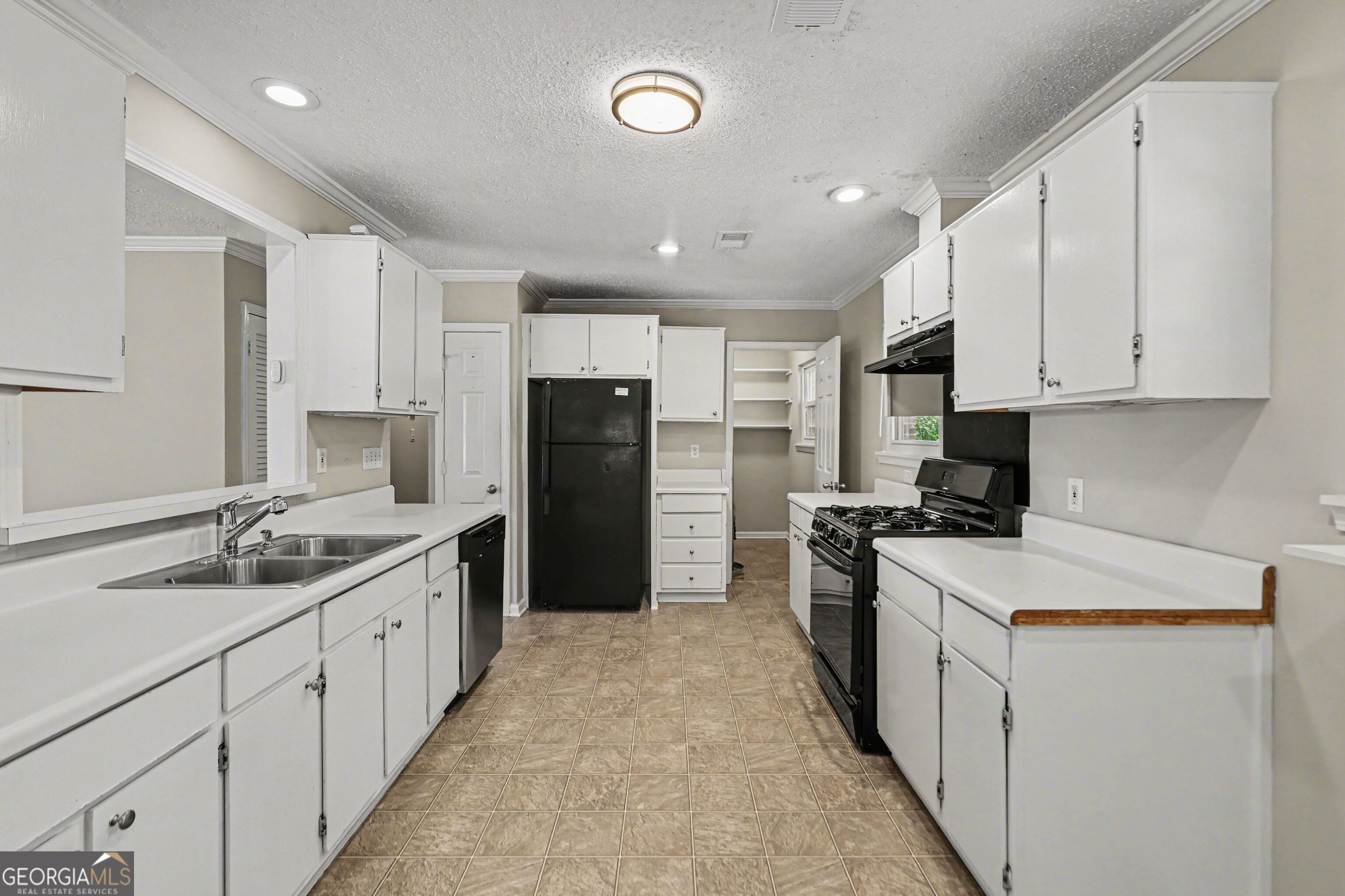 3670 Goodwin Road Austell, GA 30106 - Photo 7 of 16 a kitchen with white cabinets and stainless steel appliances