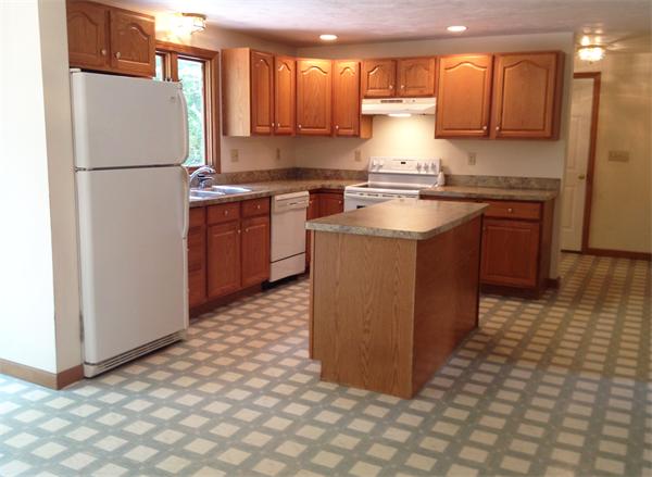 15 McGuire Road Sutton, MA 01590 - Photo 12 of 30 a kitchen with stainless steel appliances granite countertop a refrigerator a stove a sink and a microwave