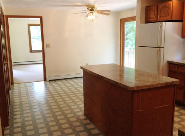 15 McGuire Road Sutton, MA 01590 - Photo 14 of 30 a kitchen with kitchen island a refrigerator a stove a sink and a refrigerator
