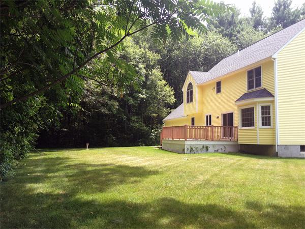 15 McGuire Road Sutton, MA 01590 - Photo 4 of 30 a view of a house with a yard