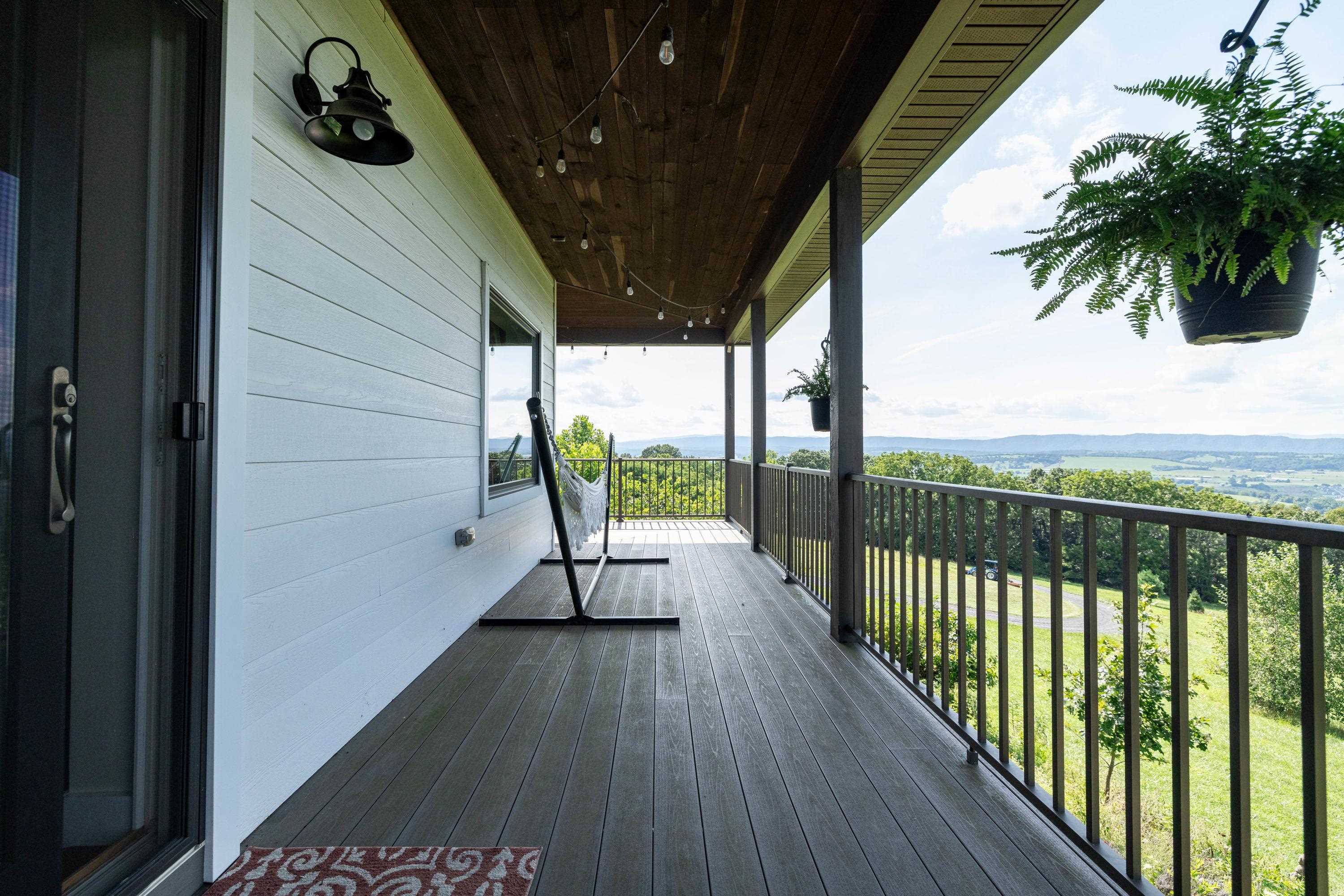 11180 Daphna Road Broadway, VA 22815 - Photo 23 of 75 The spacious front porch allows a covered area for overlooking the beautiful views the home offers. This porch features composite building materials, and is large enough for a table and chairs set.