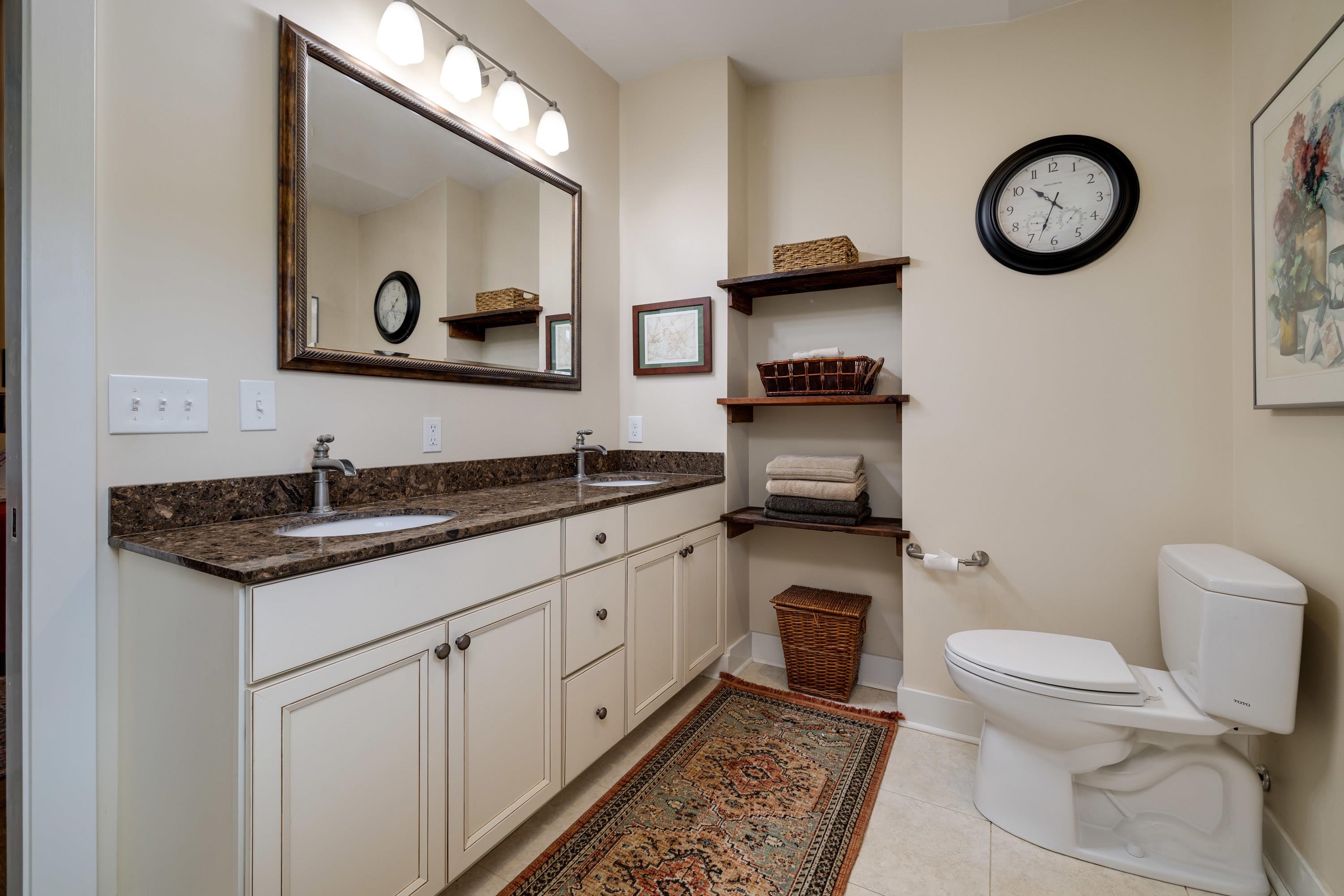 11180 Daphna Road Broadway, VA 22815 - Photo 31 of 75 This full bathroom features dual vanities, tile shower, tile flooring, and lots of storage cabinetry.