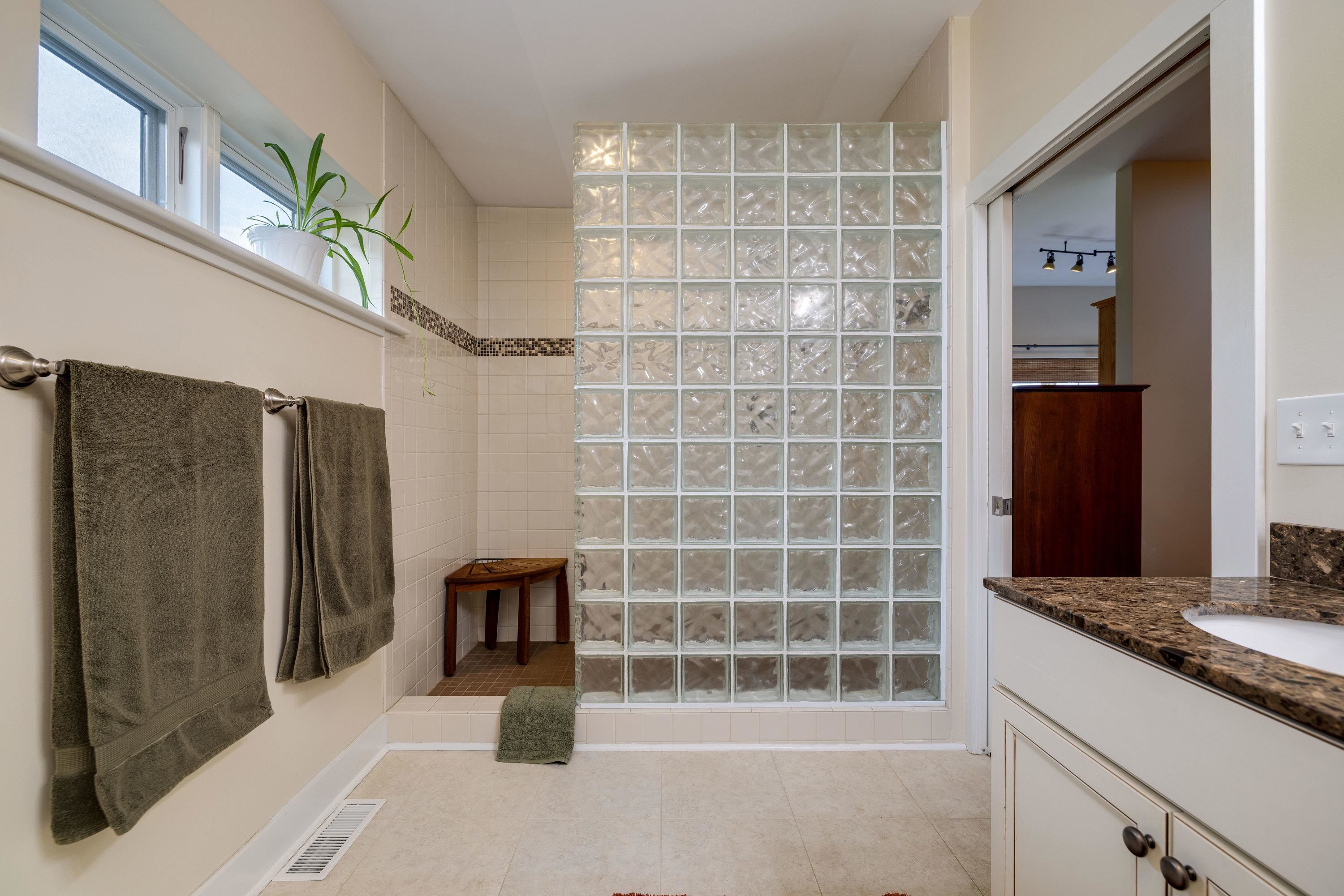11180 Daphna Road Broadway, VA 22815 - Photo 33 of 75 This full bathroom features dual vanities, tile shower, tile flooring, and lots of storage cabinetry.