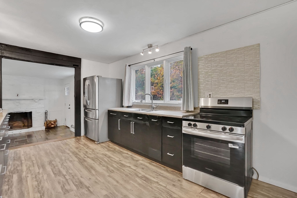 20 Pomeroy Meadow Road Easthampton, MA 01027 - Photo 12 of 42 a kitchen with stainless steel appliances granite countertop a stove refrigerator and a sink