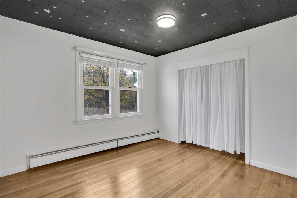 20 Pomeroy Meadow Road Easthampton, MA 01027 - Photo 16 of 42 a view of an empty room with wooden floor and a window