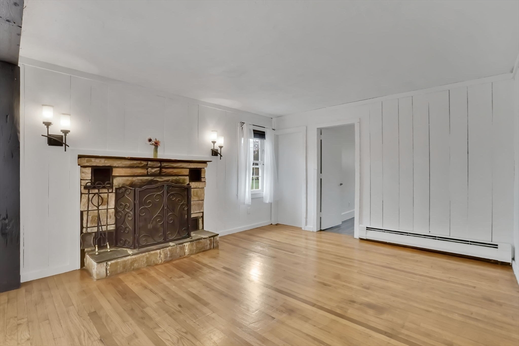 20 Pomeroy Meadow Road Easthampton, MA 01027 - Photo 24 of 42 a view of an empty room with wooden floor fireplace and a window
