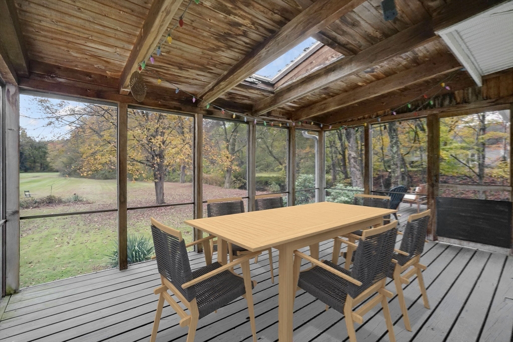 20 Pomeroy Meadow Road Easthampton, MA 01027 - Photo 28 of 42 a view of a patio with table and chairs under an umbrella with wooden floor