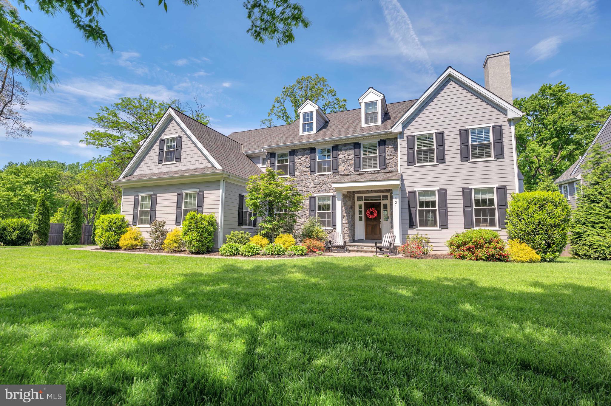 a front view of a house with garden and porch