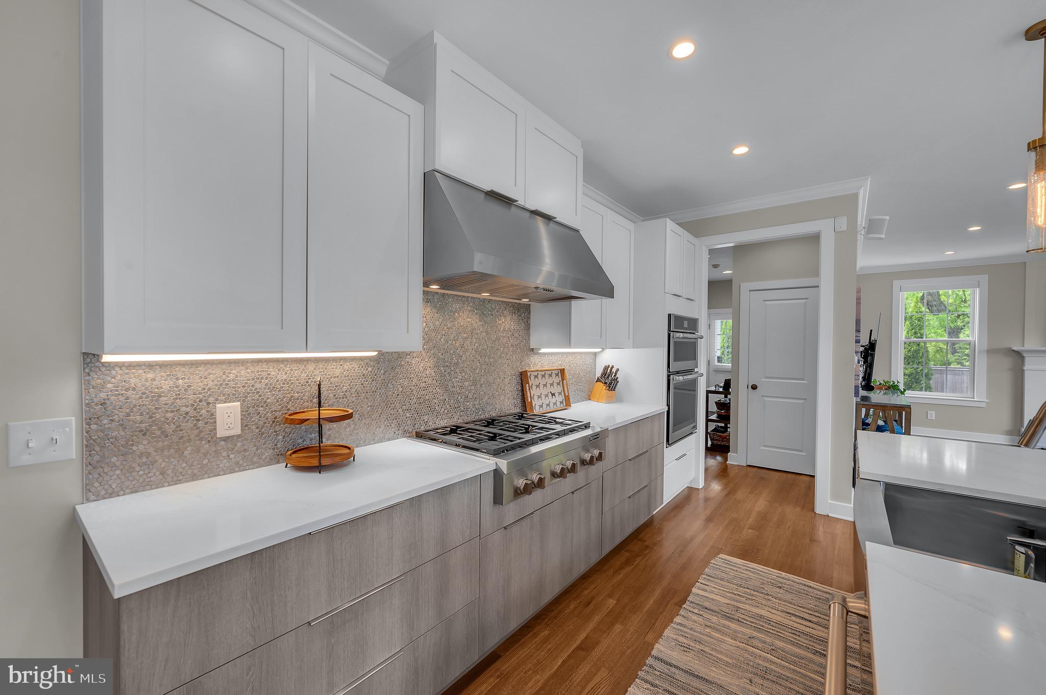 421 Howard Road Gladwyne, PA 19035 - Photo 13 of 49 a kitchen with stainless steel appliances a sink stove and cabinets