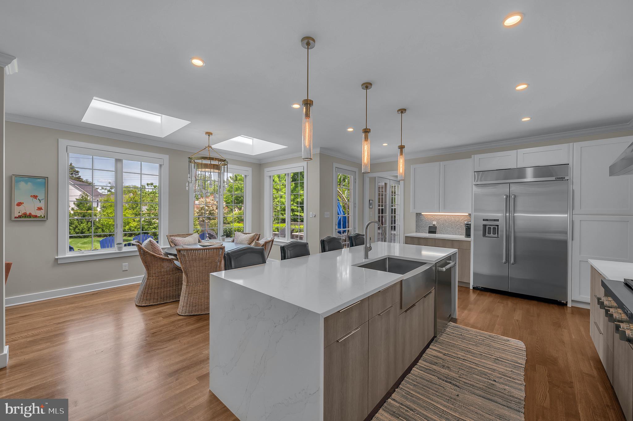 421 Howard Road Gladwyne, PA 19035 - Photo 14 of 49 a large kitchen with kitchen island a large counter top space a sink stainless steel appliances and windows