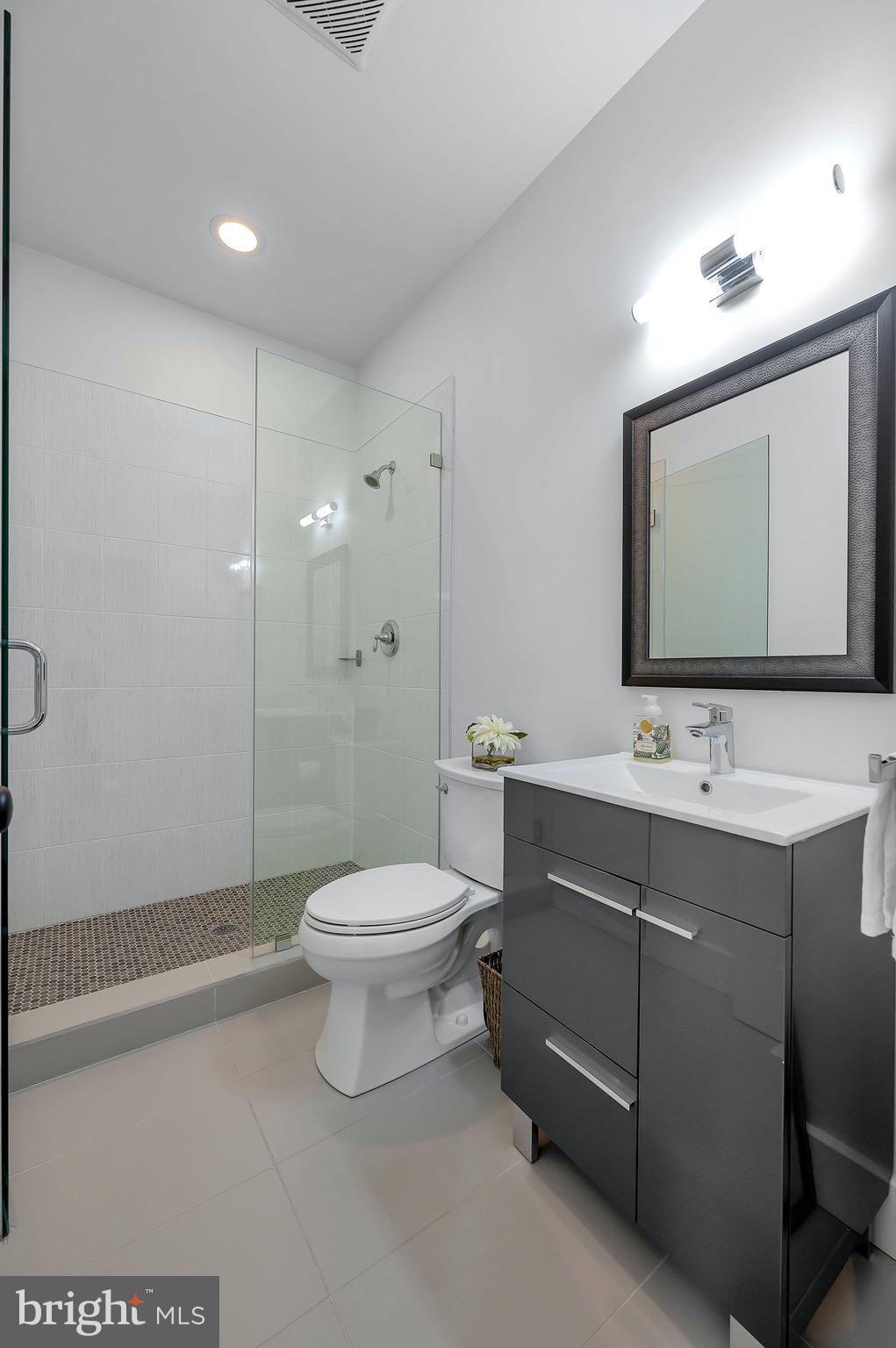 421 Howard Road Gladwyne, PA 19035 - Photo 21 of 49 a bathroom with a toilet a sink a mirror and a shower