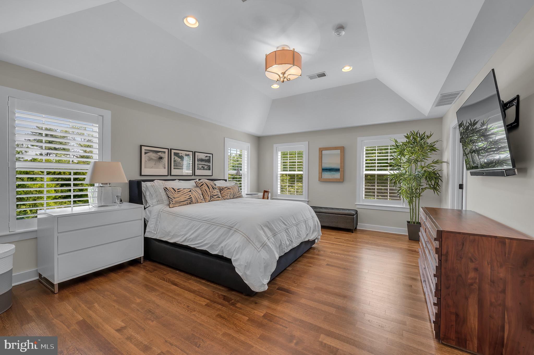 421 Howard Road Gladwyne, PA 19035 - Photo 25 of 49 a spacious bedroom with a large bed and a flat screen tv