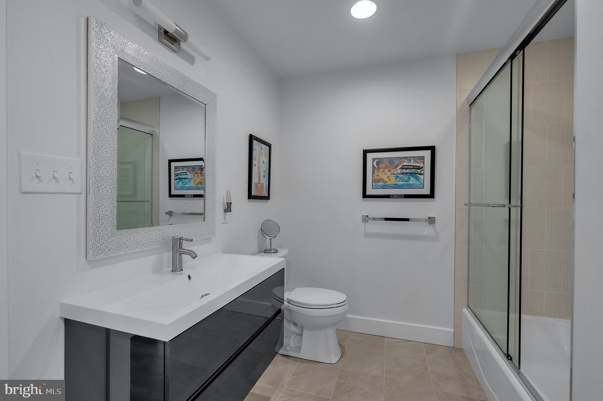 421 Howard Road Gladwyne, PA 19035 - Photo 32 of 49 a bathroom with a toilet sink and mirror