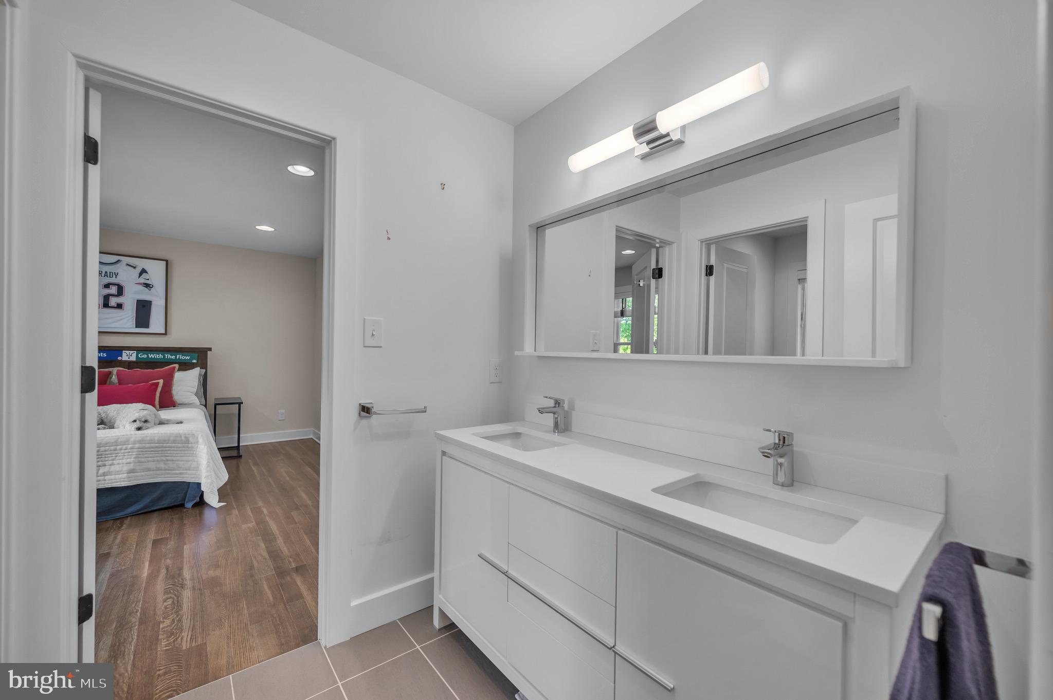 421 Howard Road Gladwyne, PA 19035 - Photo 36 of 49 a en suite bathroom with a double vanity sink and a mirror