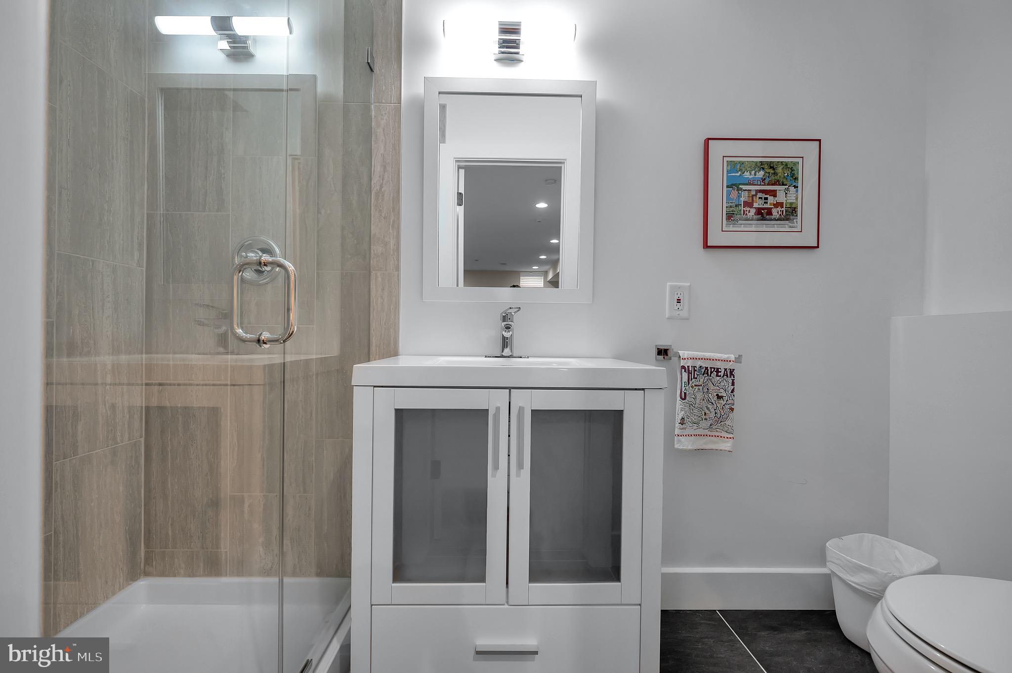 421 Howard Road Gladwyne, PA 19035 - Photo 43 of 49 a bathroom with a toilet sink and mirror