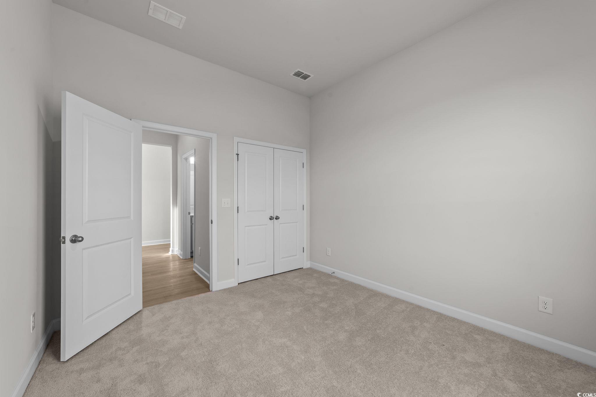 787 Ebb Tide Road Little River, SC 29566 - Photo 15 of 32 Unfurnished bedroom with carpet and a closet