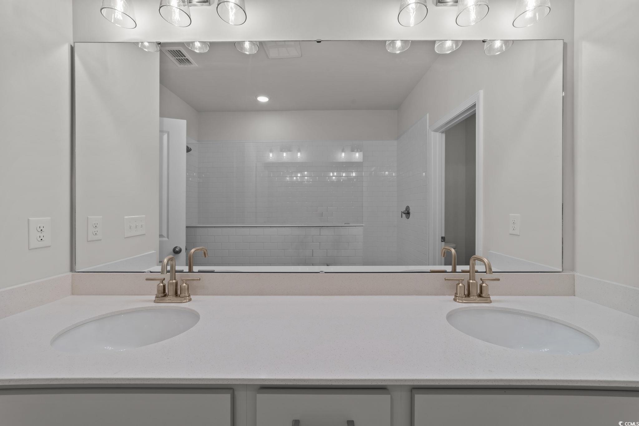 787 Ebb Tide Road Little River, SC 29566 - Photo 18 of 32 Bathroom featuring double vanity and a tile shower