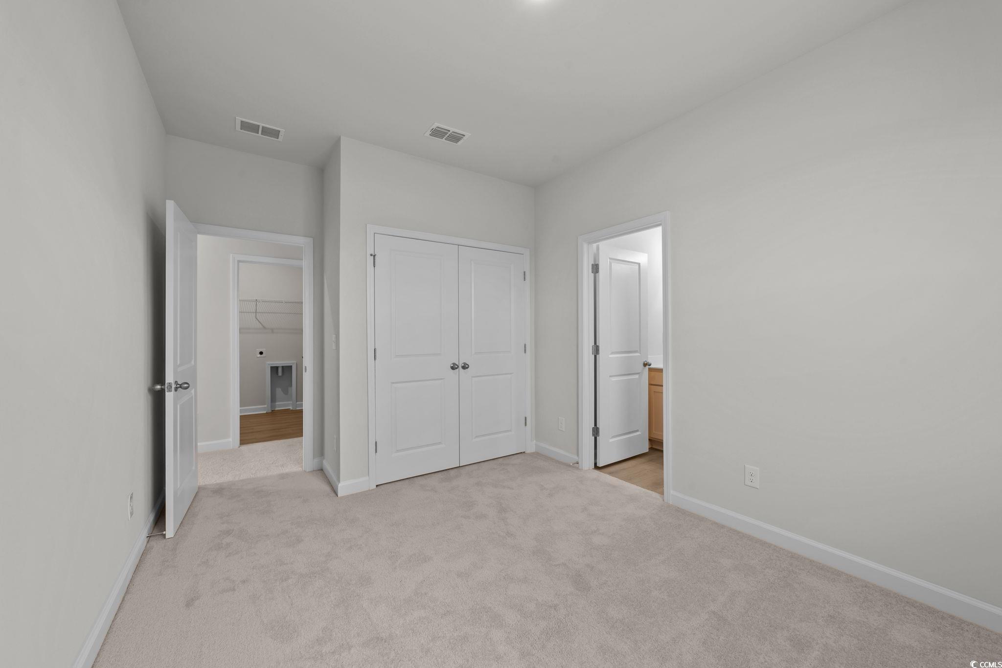 787 Ebb Tide Road Little River, SC 29566 - Photo 22 of 32 Unfurnished bedroom with light colored carpet and a closet