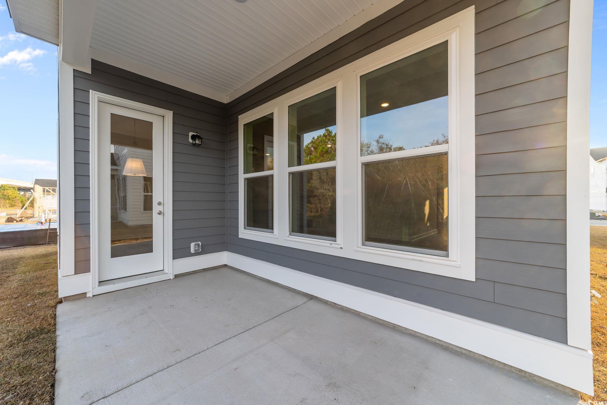 787 Ebb Tide Road Little River, SC 29566 - Photo 29 of 32 Entrance to property featuring board and batten siding and a patio area