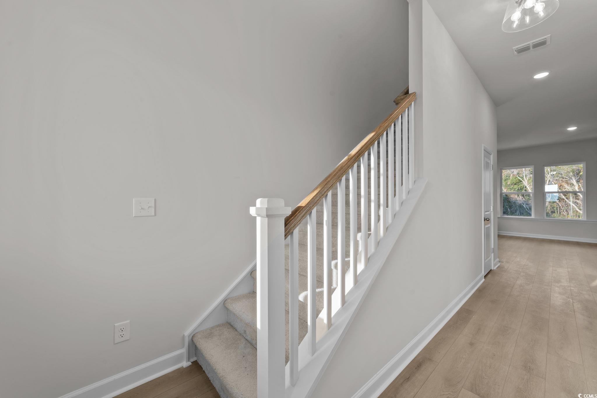 787 Ebb Tide Road Little River, SC 29566 - Photo 5 of 32 Stairway featuring wood finished floors and recessed lighting