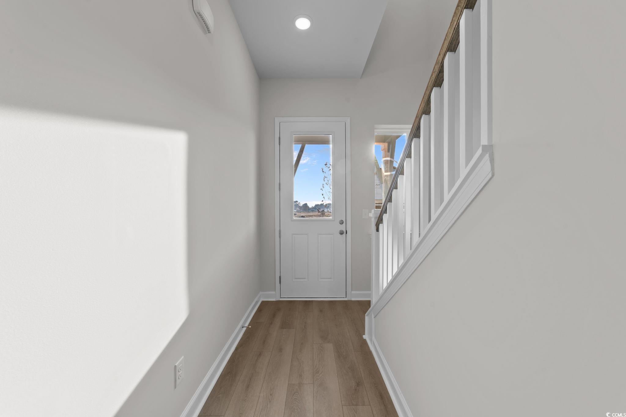 787 Ebb Tide Road Little River, SC 29566 - Photo 6 of 32 Doorway to outside featuring stairs, wood finished floors, and recessed lighting