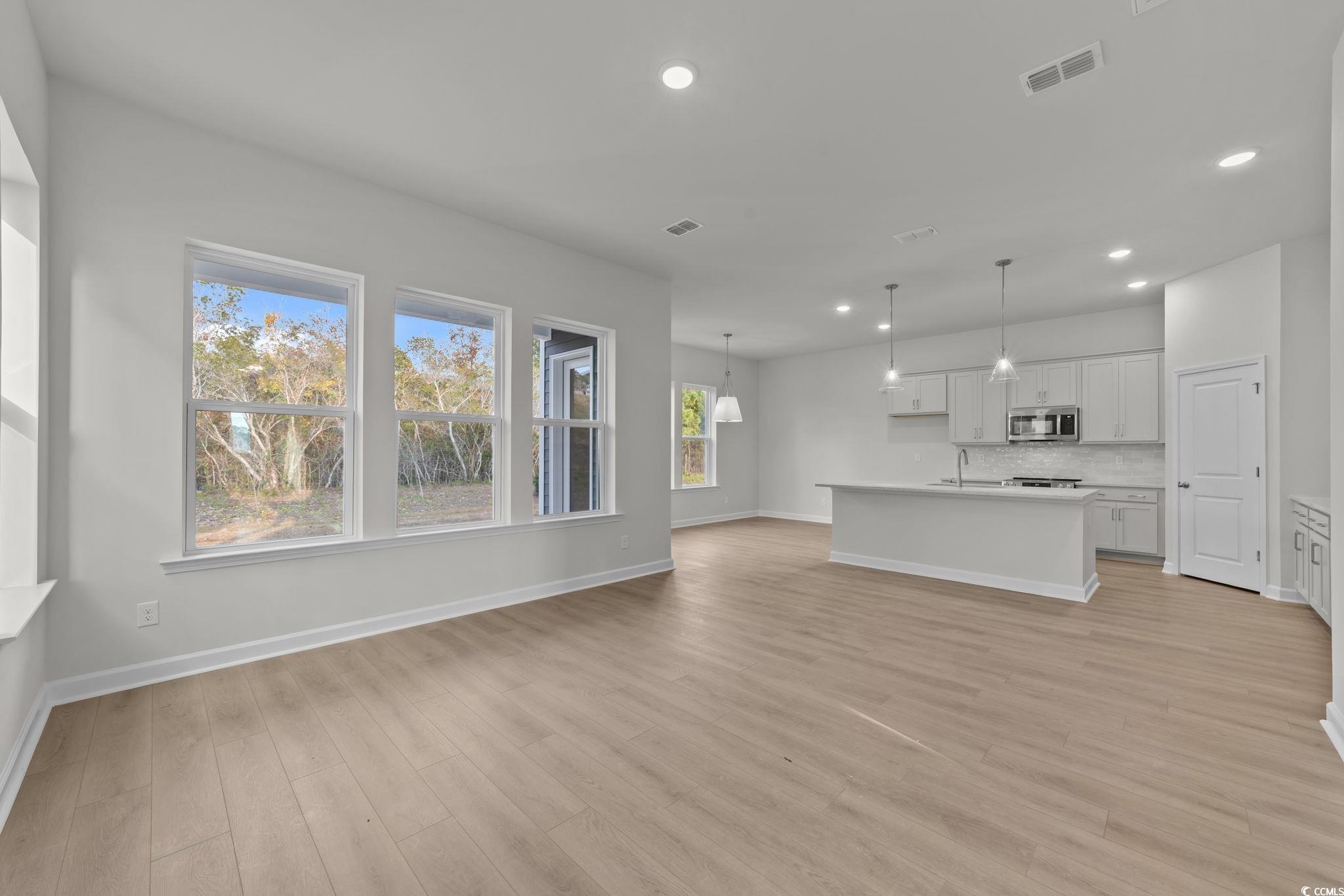 787 Ebb Tide Road Little River, SC 29566 - Photo 8 of 32 Unfurnished living room with recessed lighting and light wood-style floors