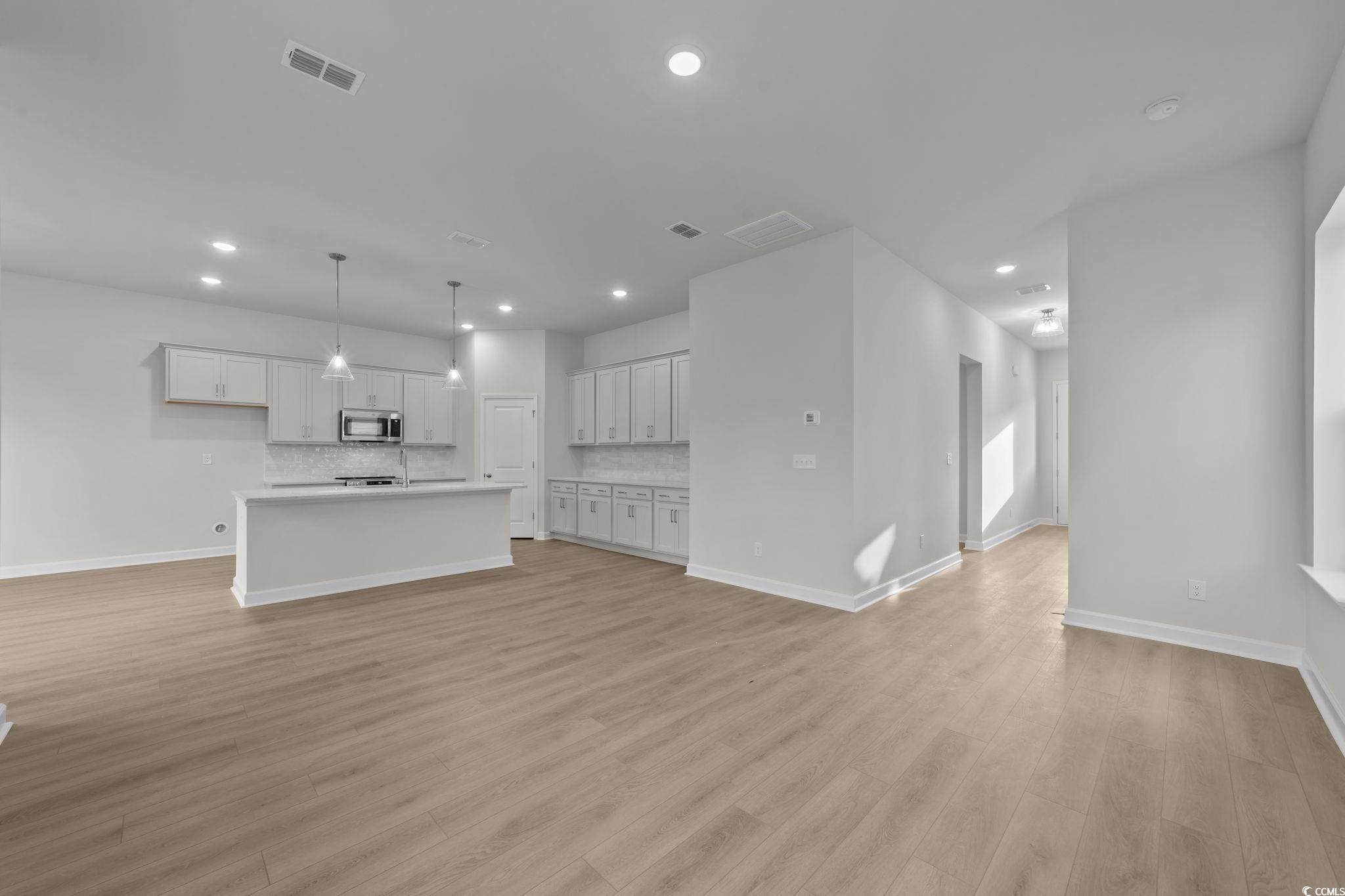 787 Ebb Tide Road Little River, SC 29566 - Photo 9 of 32 Unfurnished living room with light wood finished floors and recessed lighting