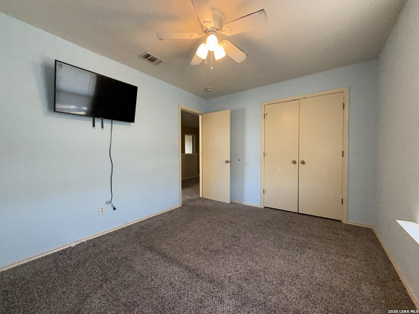 8162 Heights Valley Converse, TX 78109 - Photo 13 of 18 a view of a livingroom with an empty room and flat screen tv