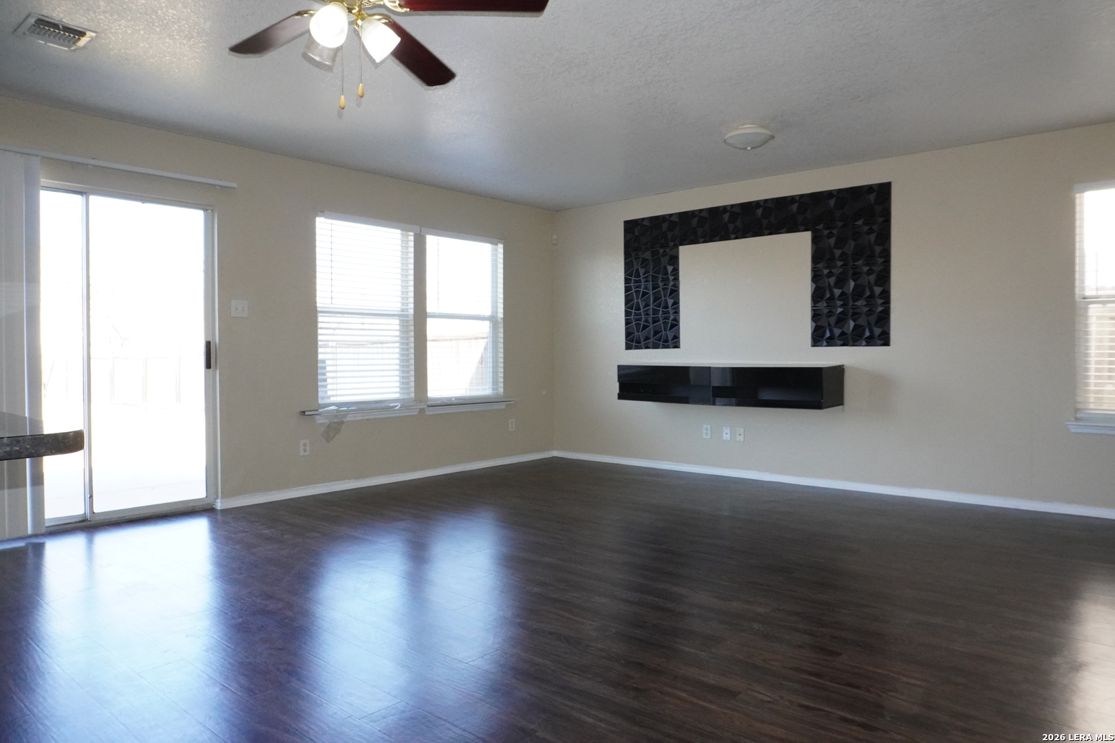 8162 Heights Valley Converse, TX 78109 - Photo 3 of 18 a view of an empty room with wooden floor and a window