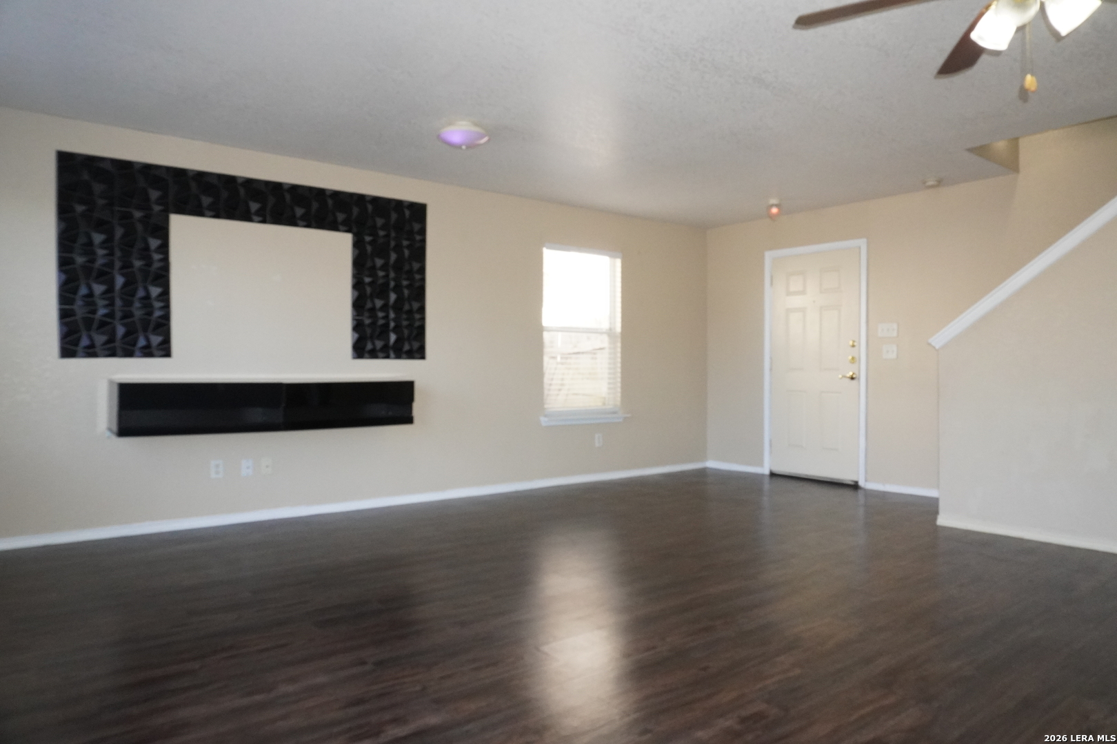 8162 Heights Valley Converse, TX 78109 - Photo 4 of 18 a view of an empty room with wooden floor and a window