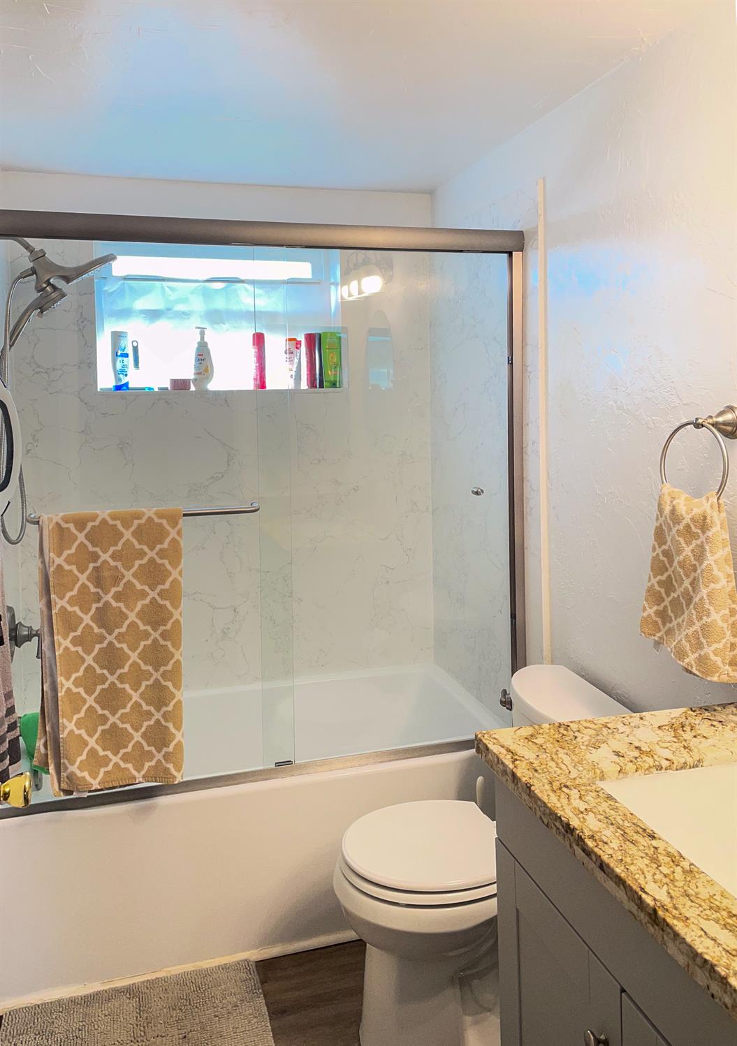 414 F Street Isleton, CA 95641 - Photo 39 of 49 a bathroom with a granite countertop sink toilet and shower