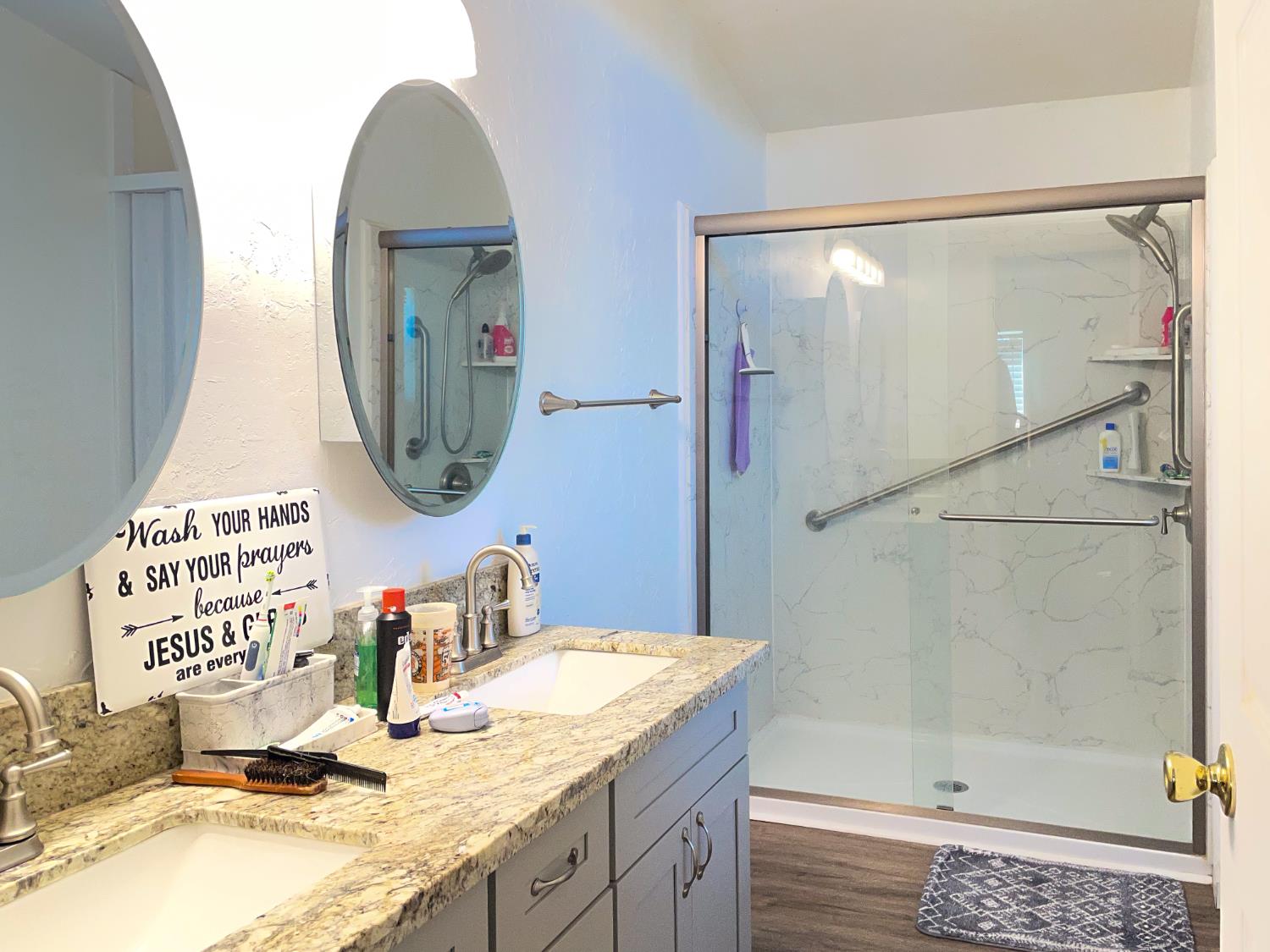 414 F Street Isleton, CA 95641 - Photo 46 of 49 a bathroom with a granite countertop sink a mirror and a shower