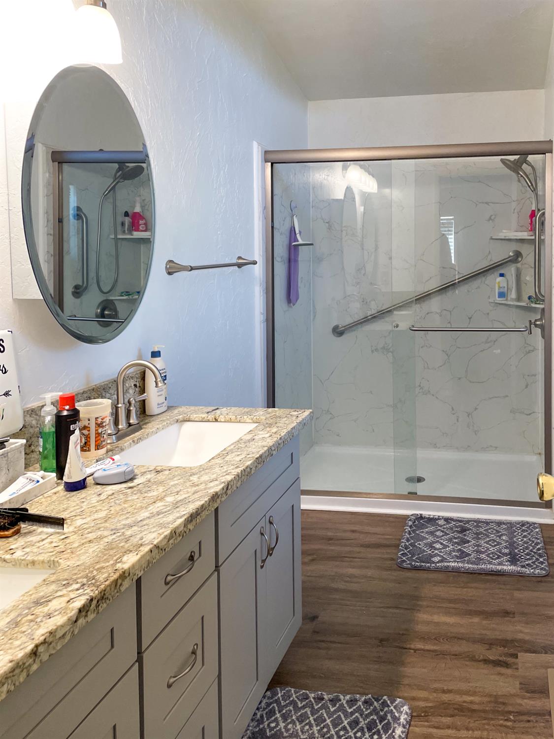 414 F Street Isleton, CA 95641 - Photo 47 of 49 a bathroom with a granite countertop sink a mirror and shower